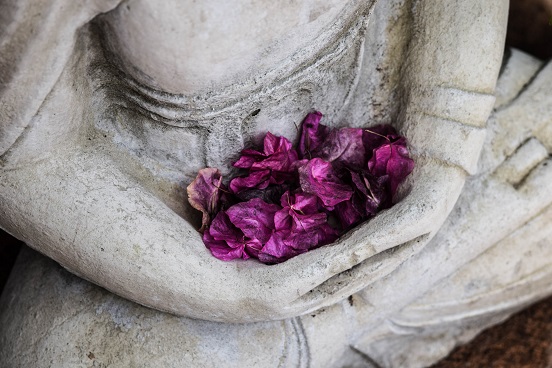 Buddhist statue with flowers