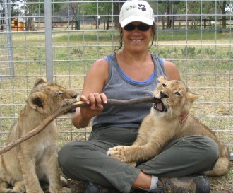 instructor Joyce Major with lion cubs